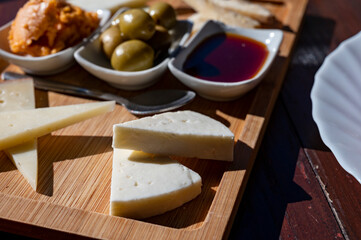 Dinner at guachinche, typical Canary Island establishment on Tenerife, where locally produced white or red wine served accompanied by homemade traditional food, tapas and goat cheese