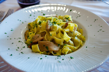 Italian food, firsh course dish, fresh homemade pasta tagliatelle with porcini mushrooms, Parma, Emilia Romagna, Italy