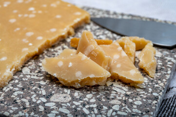 72 months very old Italian parmigiano-reggiano parmesan cheese from Parma has amber color, dry, extremely grainy and crumbly with very intense taste.