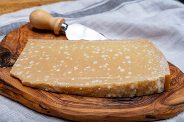 72 months very old Italian parmigiano-reggiano parmesan cheese from Parma has amber color, dry, extremely grainy and crumbly with very intense taste.