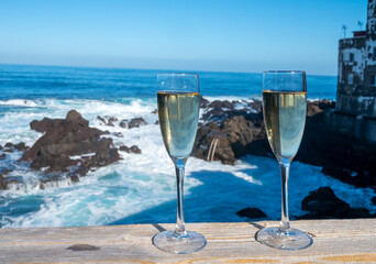 New year celebration with two glasses of champagne or Spanish cava sparkling wine and view on blue Atlantic ocean, Canary islands, winter tourists destination