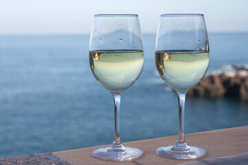 Drinking of white wine with view on blue Atlantic ocean on Tenerife, Canary islands, Spain