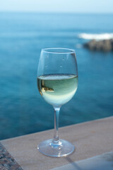 Drinking of white wine with view on blue Atlantic ocean on Tenerife, Canary islands, Spain