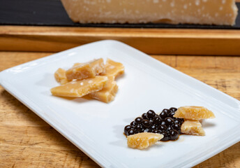 Tasting of 72 months very old Italian parmigiano-reggiano parmesan cheese from Parma   with black pearls of balsamic vinegar DOP from Modena.
