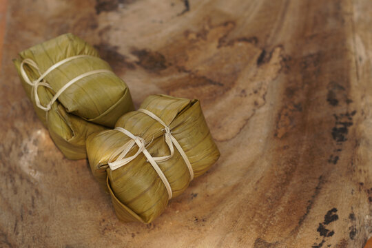 Thai dessert, sticky rice steamed with banana in banana leaf (Khao Tom Mad or Khao Tom Pad) at Thailand, Sticky rice steamed with banana isolated on white background, stacked with clipping path.