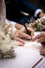 Bride and Groom signing after the exchange of vows - French wedding along the French Riviera -...