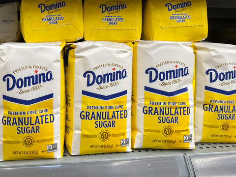 Miami, Fl, USA - January 6, 2022: Domino Sugar 4 Lb Bags On The Shelf In A Supermarket. The Domino Brand Name Was Officially Adopted In 1901 By A New York-based Sugar Company.
