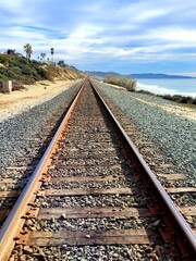 Fototapeta na wymiar Train rails on the beach