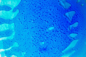 Transparent clear blue liquid serum gel smudge with bubbles textured background