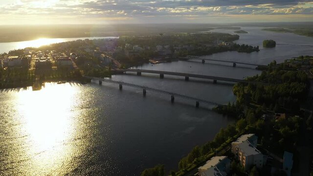 Aerial view of bridges in downtown Tornio, golden hour in Finland - tracking, drone shot