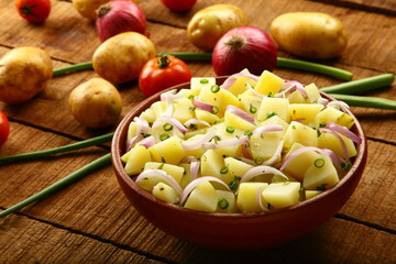 Boiled potato slices  with exotic fresh herbs- healthy  vegan diet meal.