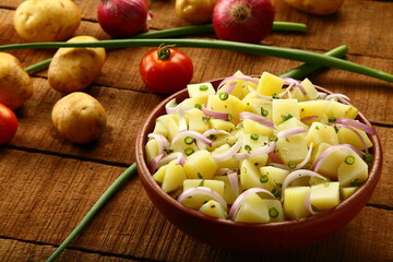 Boiled potato slices  with exotic fresh herbs- healthy  vegan diet meal.