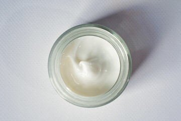 Cosmetic moisturizing anti wrinkle white cream in glass jar on white background