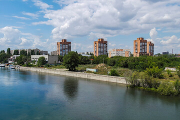 View of the city of Ust-Kamenogorsk (kazakhstan). Old residential area. Soviet built multistory apartment buildings. Irtysh river. Green trees and blue sky