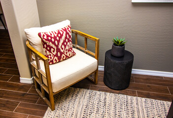 Wooden Arm Chair With Decorator Pillow In Corner Of Den