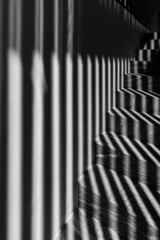 Graphic shapes - parallel shadow lines on stairs. High contrast.
