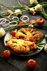 Traditional cooking recipes- homemade  grilled cauliflower and vegetables in iron skillet.