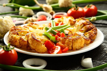Plate of homemade roasted cauliflower  and vegetables. Healthy vegan diet meal.