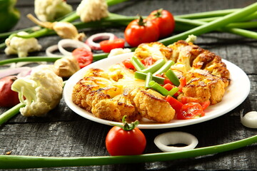 Homemade grilled cauliflower  and organic  vegetables. tomatoes, green beans onions, healthy vegan diet meal.