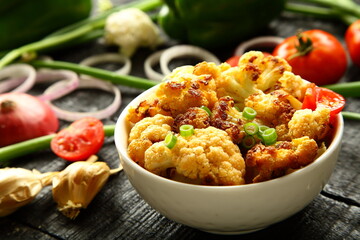 Delicious cauliflower roast curry served in ceramic bowl, 