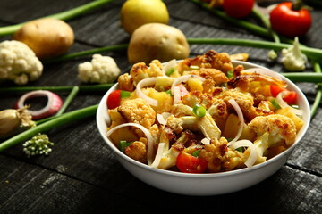 Healthy vegetarian curry meal- cauliflower roast with exotic Indian spices and herbs.