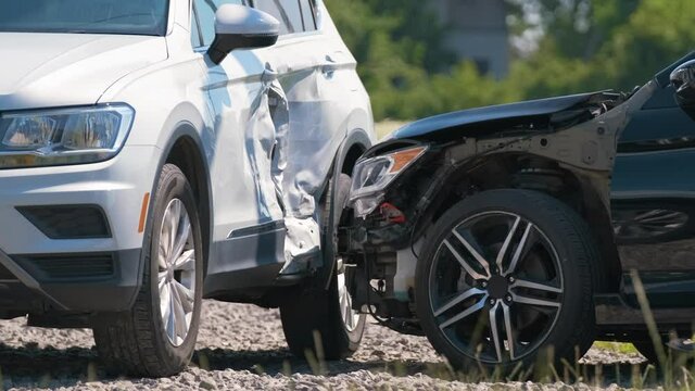 Cars crashed heavily in road accident after collision on city street. Road safety and insurance concept