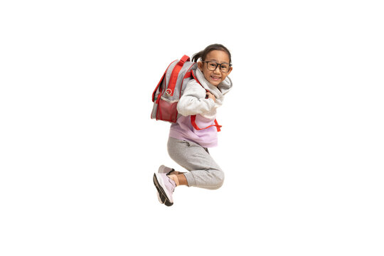 Funny Asian Child Girl Carry Backpack Jumping Isolated On White Background