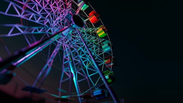 A colourful Ferris wheel spinning slowly during a dark night in an endless loop