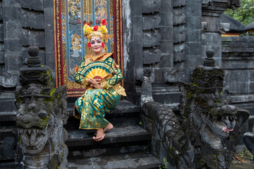 Balinese dancer woman in gold costume, Temple Bali Indonesia