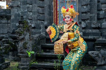 Balinese dancer woman in gold costume, Temple Bali Indonesia