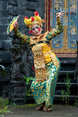 Balinese dancer woman in gold costume, Temple Bali Indonesia