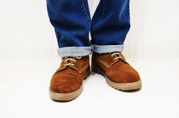 Botas cafés para hombre. Hombre vistiendo pantalón azul y botas usadas en buen estado.