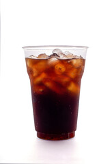 Soft drink with soda and ice cubes in plastic glass isolated on a white background.