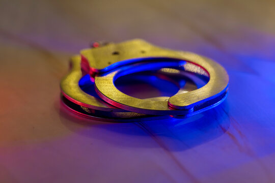 Flashing Red And Blue Police Lights Of Handcuffs Police