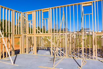 Fototapeta premium View new home under construction framing of beams stick built building