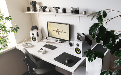 General view home workplace of gamer with computer and gamepad.  © Aboltin