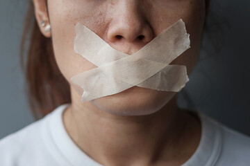 woman with mouth sealed in adhesive tape. Free of speech, freedom of press, Human rights, Protest...