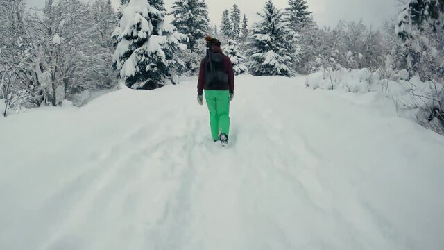 woman walking in snowy mountains time lapse
