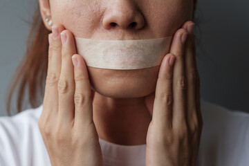 woman with mouth sealed in adhesive tape. Free of speech, freedom of press, Human rights, Protest...
