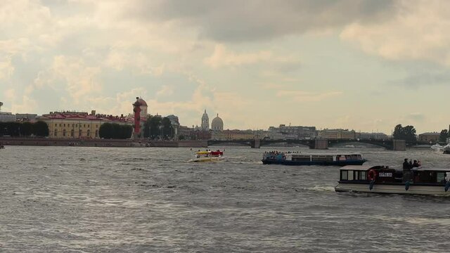 Tourist Boats Sailing Across The Neva River In Russia With Saint Petersburg City In Background. wide
