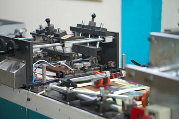 Photo of industrial print offset machine printing and processing labels for packaging products
