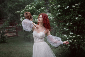 Girl in a white dress with an owl 