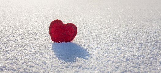 snow banner with red heart on an icy crust on a cold winter morning, valentine's day card,