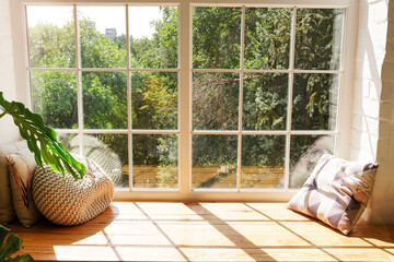 Cozy window sill with monstera and pillows indoors. Sunlights in home © Nastya