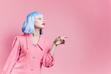 portrait of a woman in blue wig pink dress red lips pink background