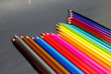 Beautiful colored pencils for drawing objects on a black background