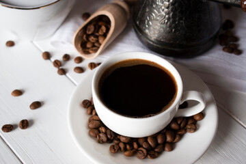 cup of black coffee with grains and turk on a napkin
