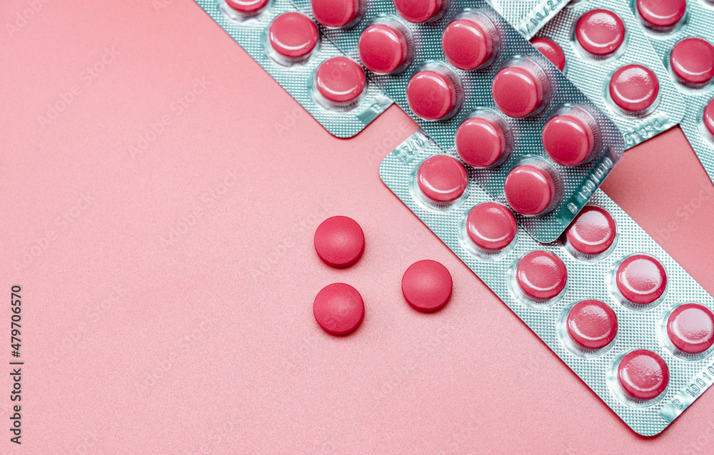 Wall mural top view of pink tablets pill and blister pack of pills on pink background. prescription drugs. phar