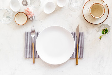 Crockery set - table setting for dinner with dishes and glasses