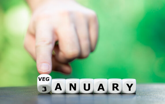 Symbol for the Veganuary, a vegan lifestyle for the month of January. Hand turns dice and changes the word January to Veganuary.
